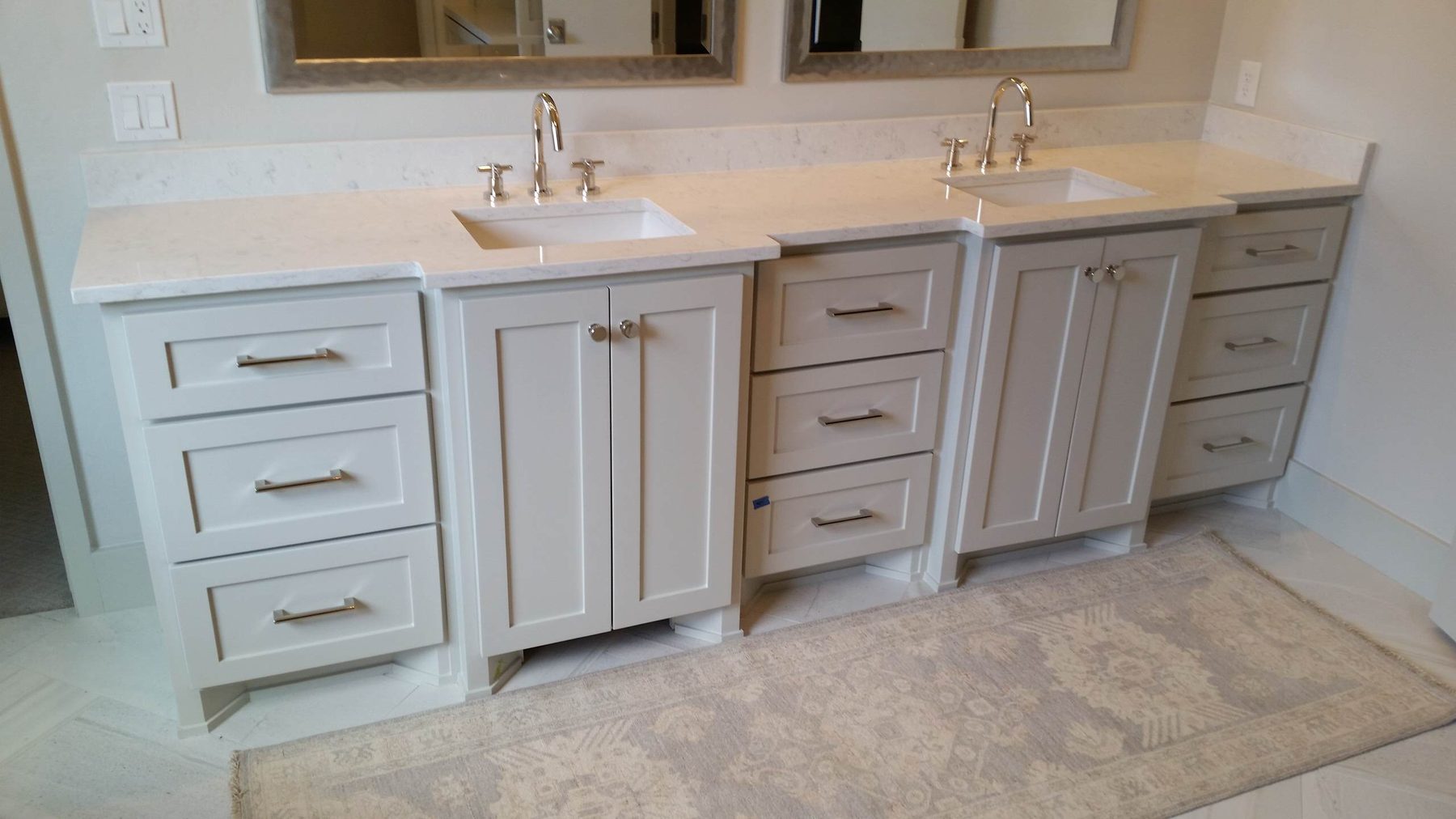 Grey painted double vanity with two undermount sinks and polished nickel hardware