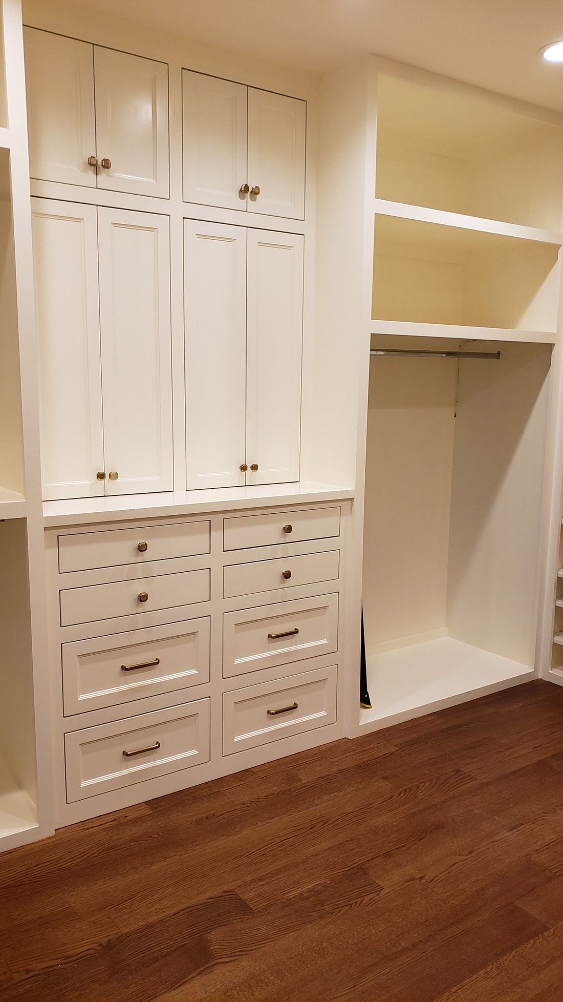Painted closet system with drawer banks, adjustable shelving and hanging sections